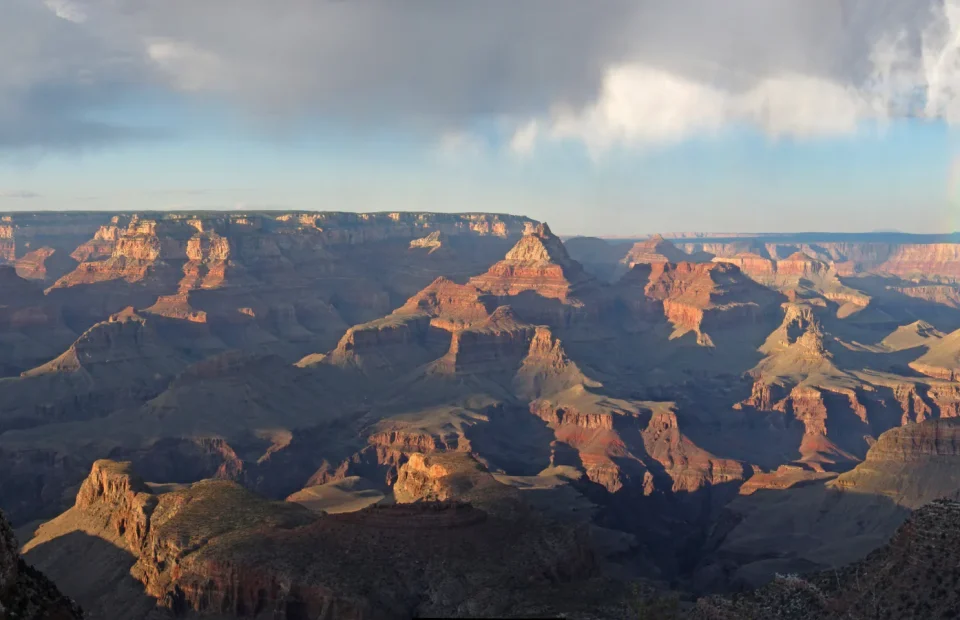 Sunlit buttes beneath a passing rainstorm in Grand Canyon National Park