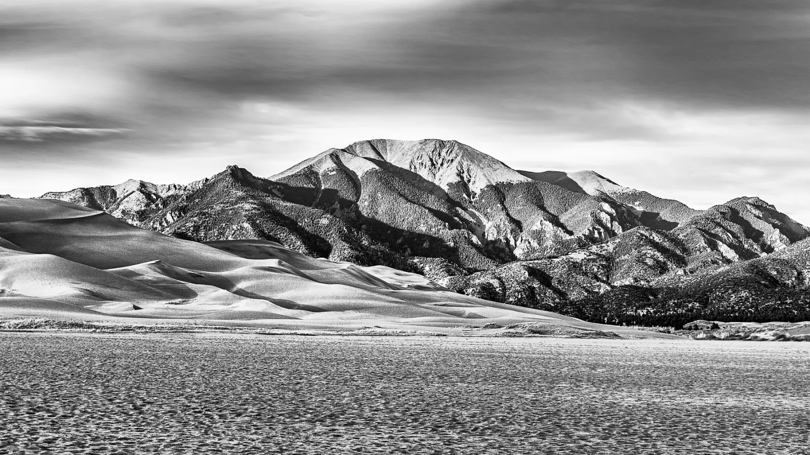 Sand ridges and grassland below Carbonate Mountain in Great Sand Dunes National Park