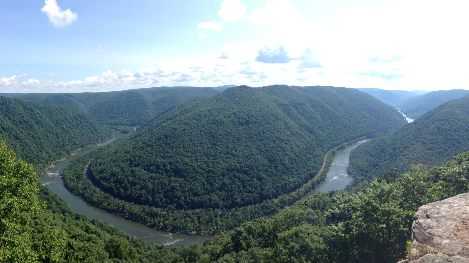 The New River bends between forested walls in New River Gorge National Park and Preserve